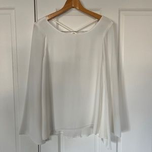 NWT White top with trumpet arms and crisscross back